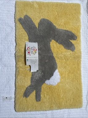 Bunny bath mat. 20x32”. Pale yellow, grey and white. NWT. Slip free back